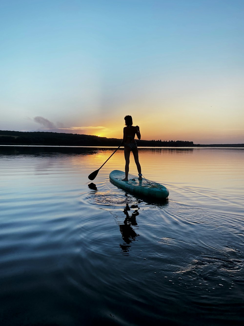 man in black shirt riding on green kayak on body of water during daytime