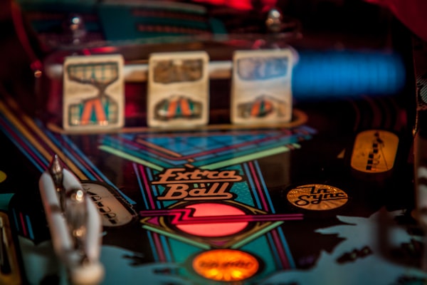 Close up of a pinball table. "Extra ball" light is activated.