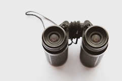 black binoculars on white surface