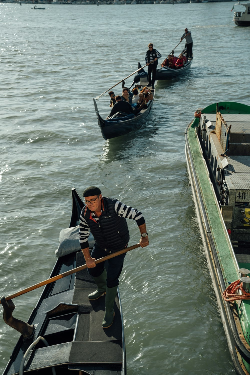 man in black and white jacket riding on boat during daytime