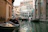 A peaceful view of Venice canals with gondolas gliding under historic bridges.