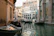 A peaceful view of Venice canals with gondolas gliding under historic bridges.