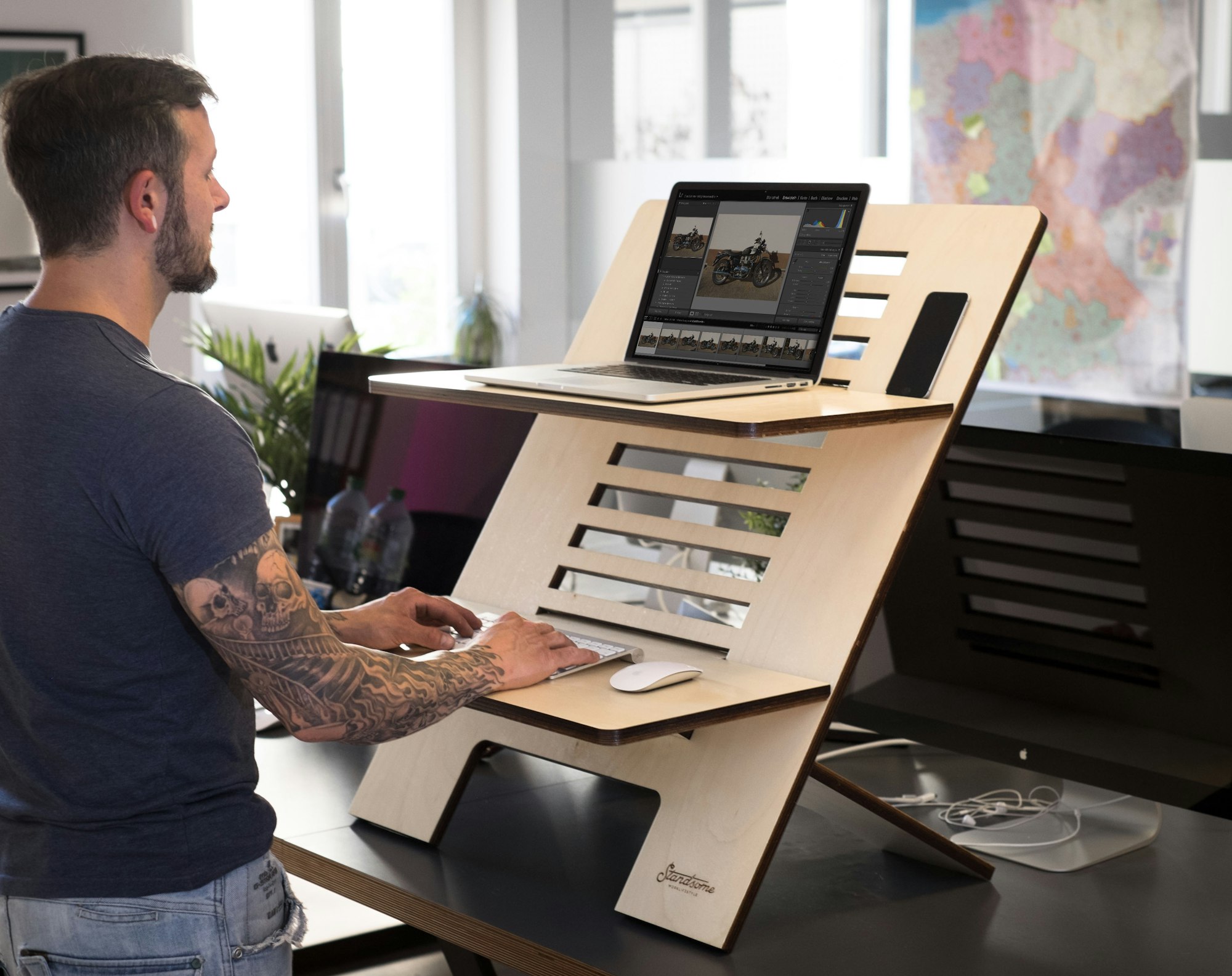 Modern man working on a height-adjustable standing desk