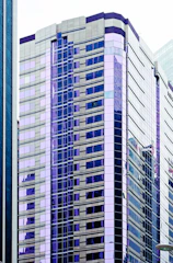 Modern residential buildings with purple and gold accents reflecting investment success.