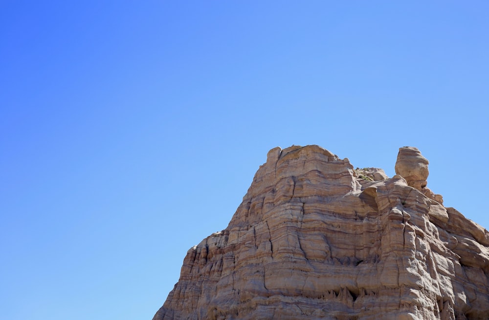 brown rocky mountain under blue sky during daytime