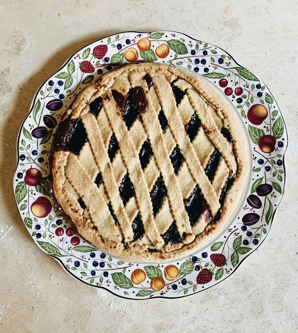 brown pie on white and blue floral ceramic plate