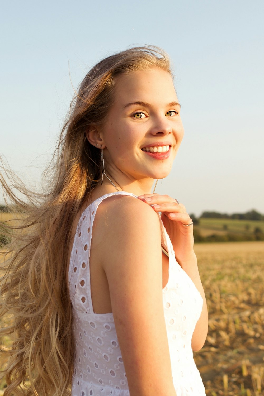 smiling woman in white tank top