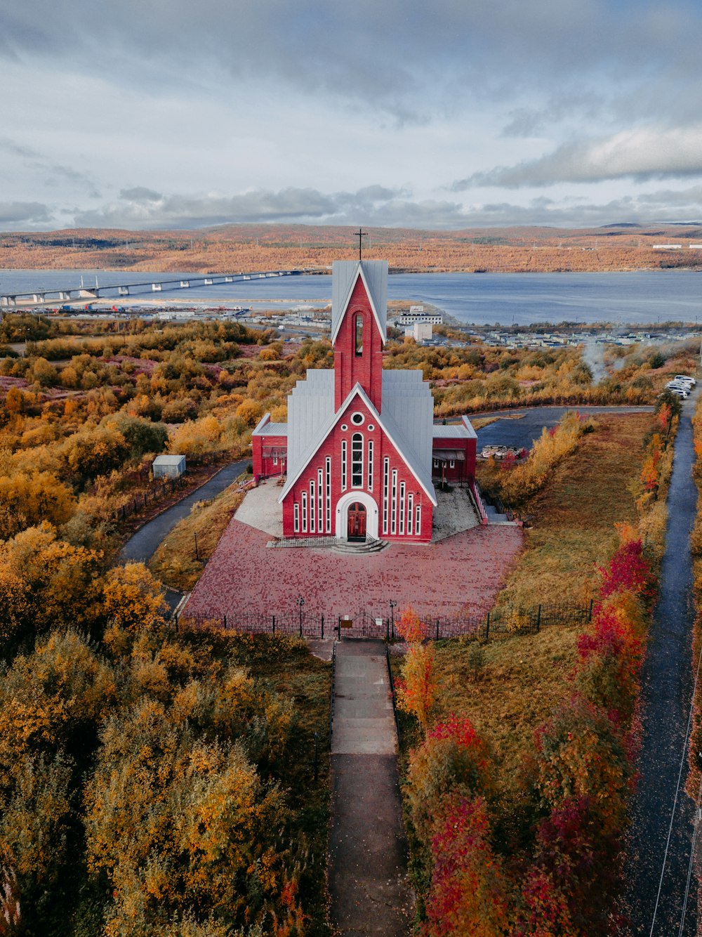 red and white concrete church near green grass field during daytime