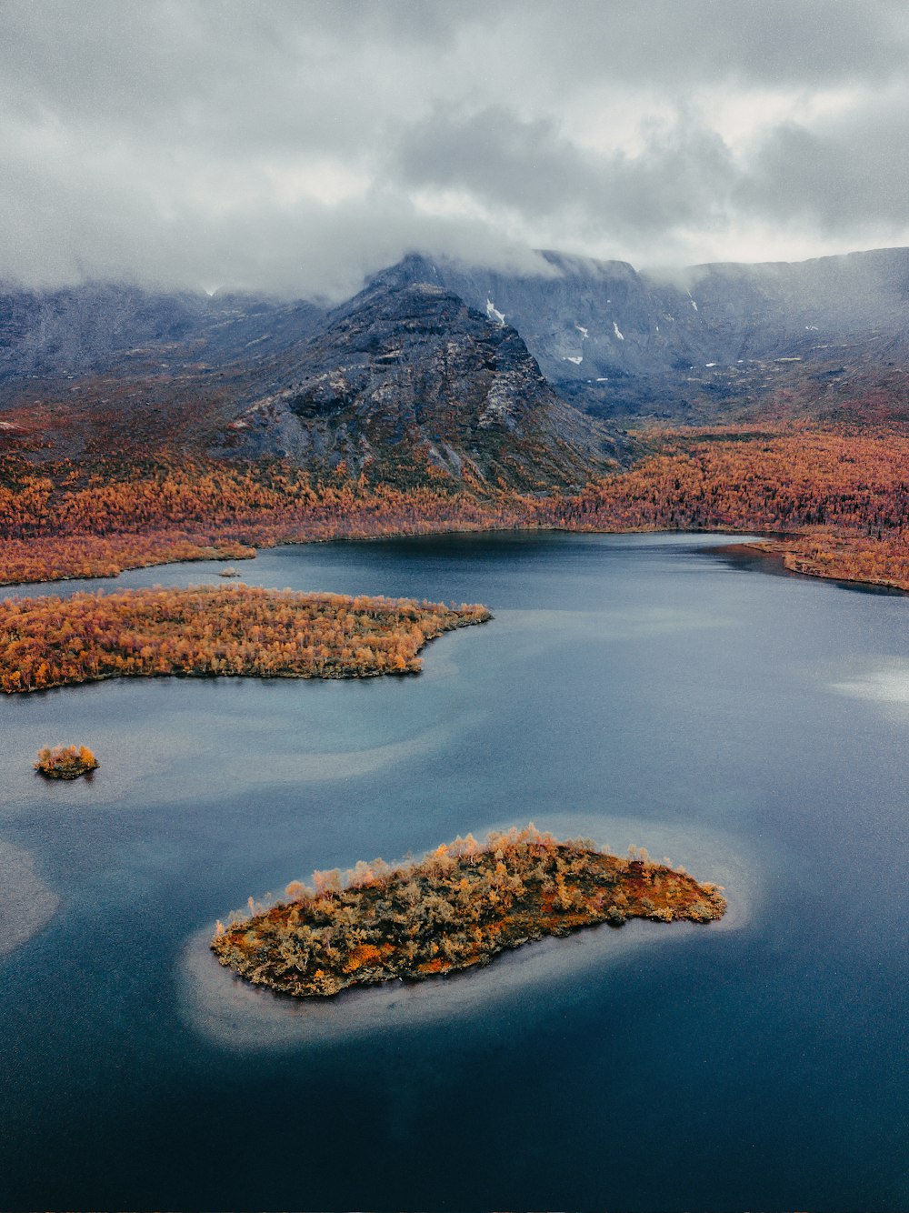 lake in the middle of mountains during daytime