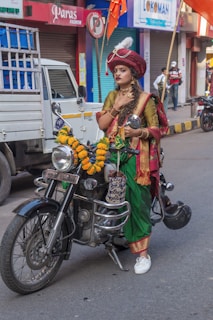 woman in red and yellow dress riding on black motorcycle during daytime
