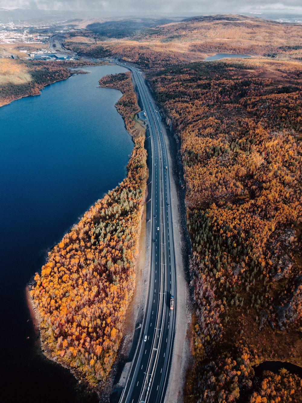 aerial view of brown field beside blue lake during daytime