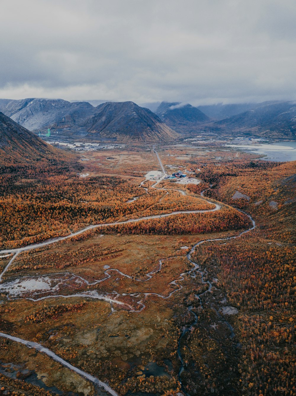 brown and green mountains under white clouds during daytime