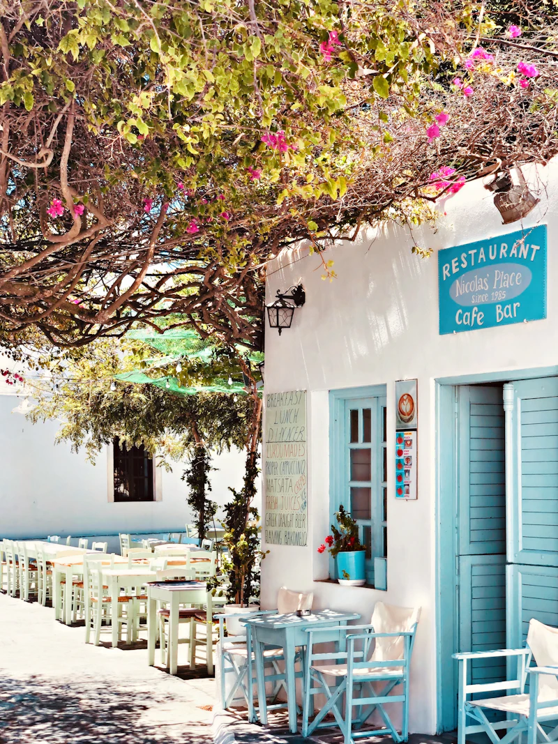 Blue doors and bougainvillea over a café terrace