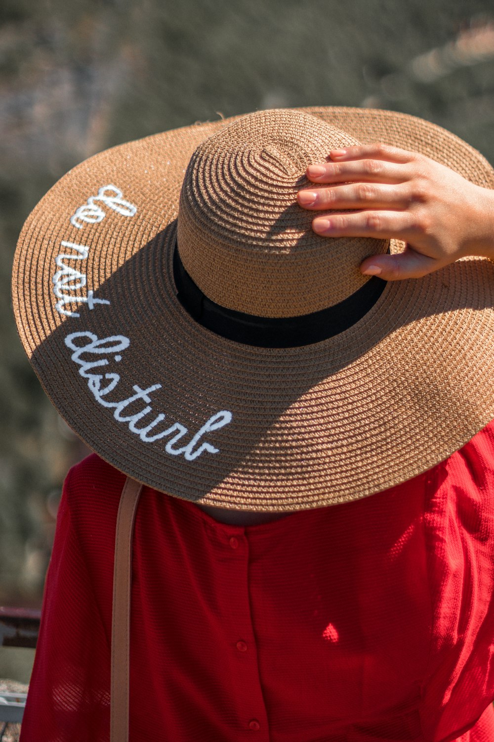 person in red and white jacket wearing brown and black fedora hat