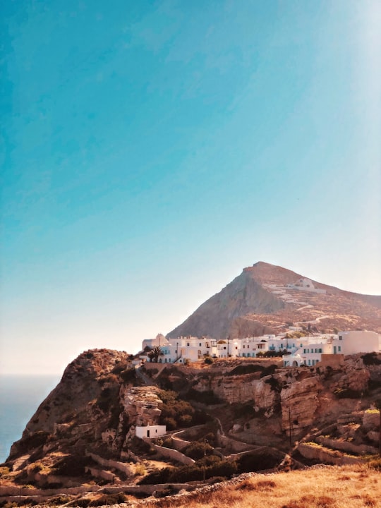 brown mountain under blue sky during daytime in Folegandros Greece