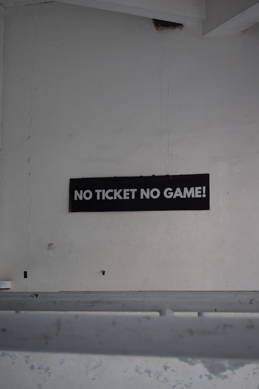 Stadium wall sign reading No Ticket No Game