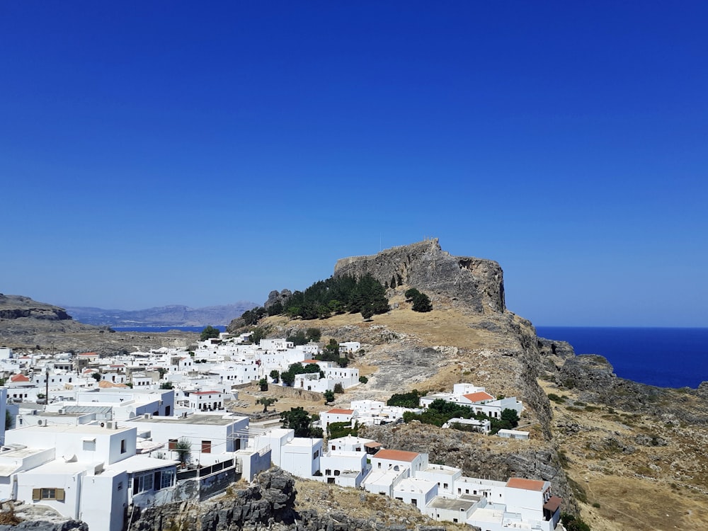 white concrete houses on mountain during daytime