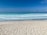 A serene beach scene in Veracruz with gentle waves and a clear sky.