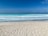 A serene beach scene in Veracruz with gentle waves and a clear sky.