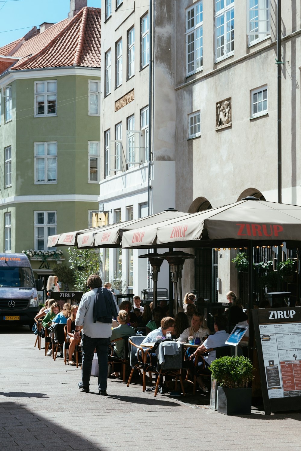 people sitting on chair near building during daytime