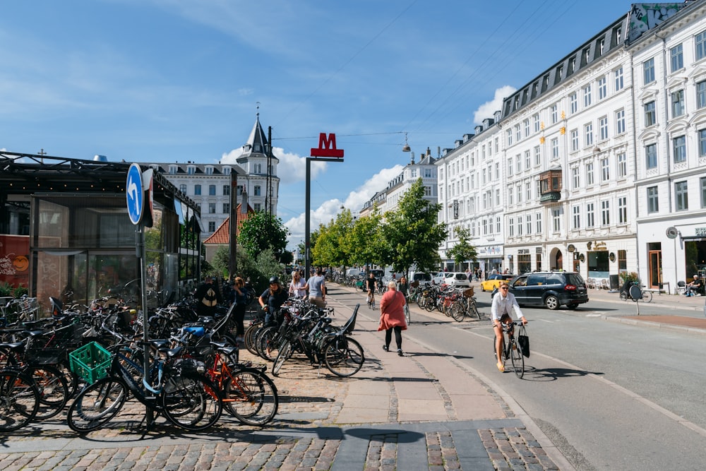 Menschen, die tagsüber auf dem Bürgersteig in der Nähe des weißen Betongebäudes spazieren gehen