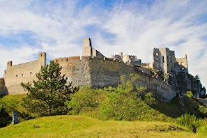 Ancient stone ruins of Rabí castle standing proudly against a cloudy sky.