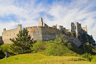 Ancient stone ruins of Rabí castle standing proudly against a cloudy sky.