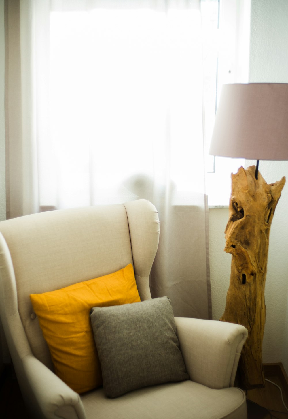 white and brown table lamp beside white couch