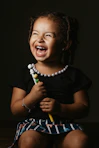 girl in black crew neck t-shirt smiling