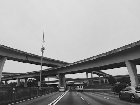 grayscale photo of a bridge