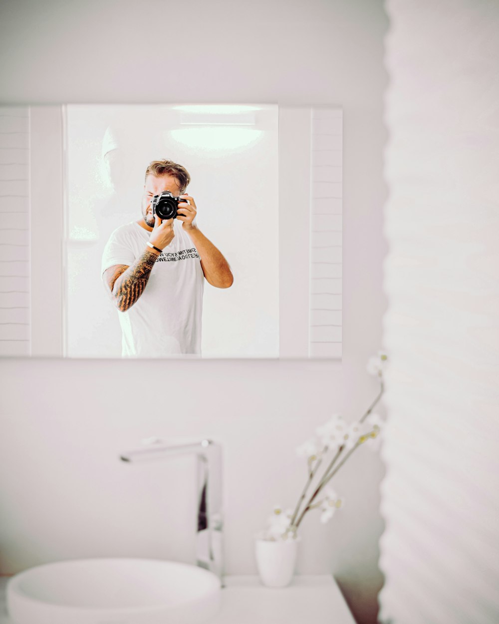 man in white crew neck t-shirt wearing black sunglasses