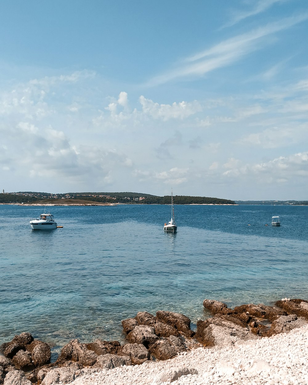 white boat on sea during daytime