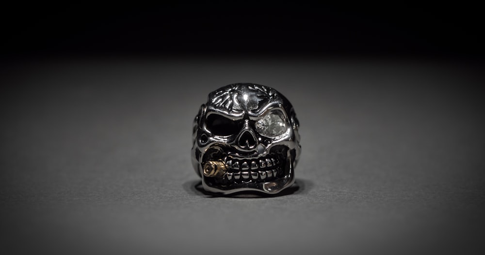 silver skull on white table