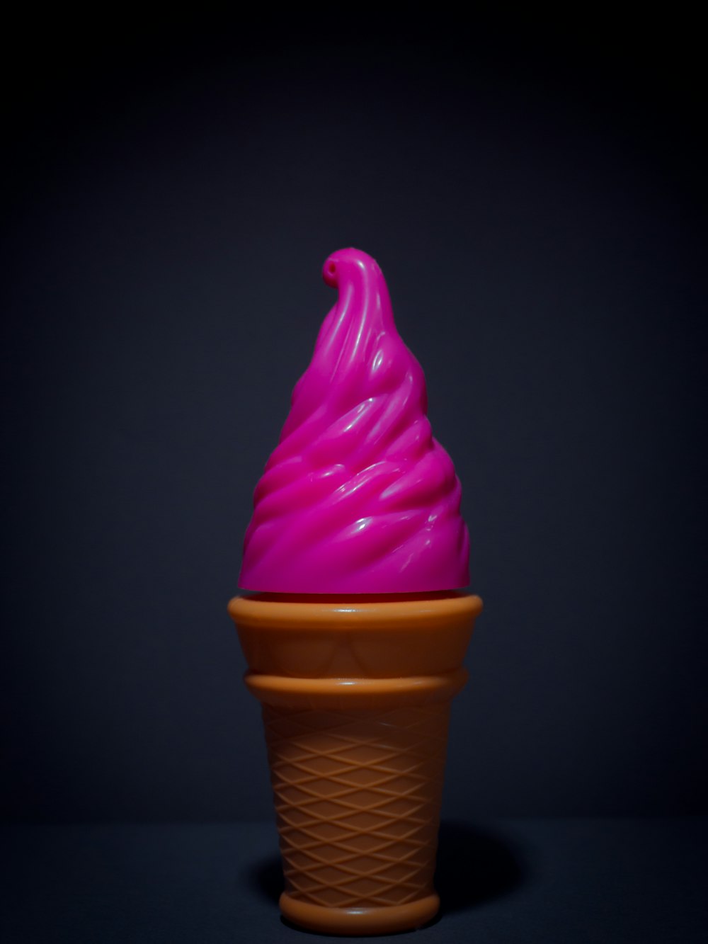 pink ice cream on brown cone