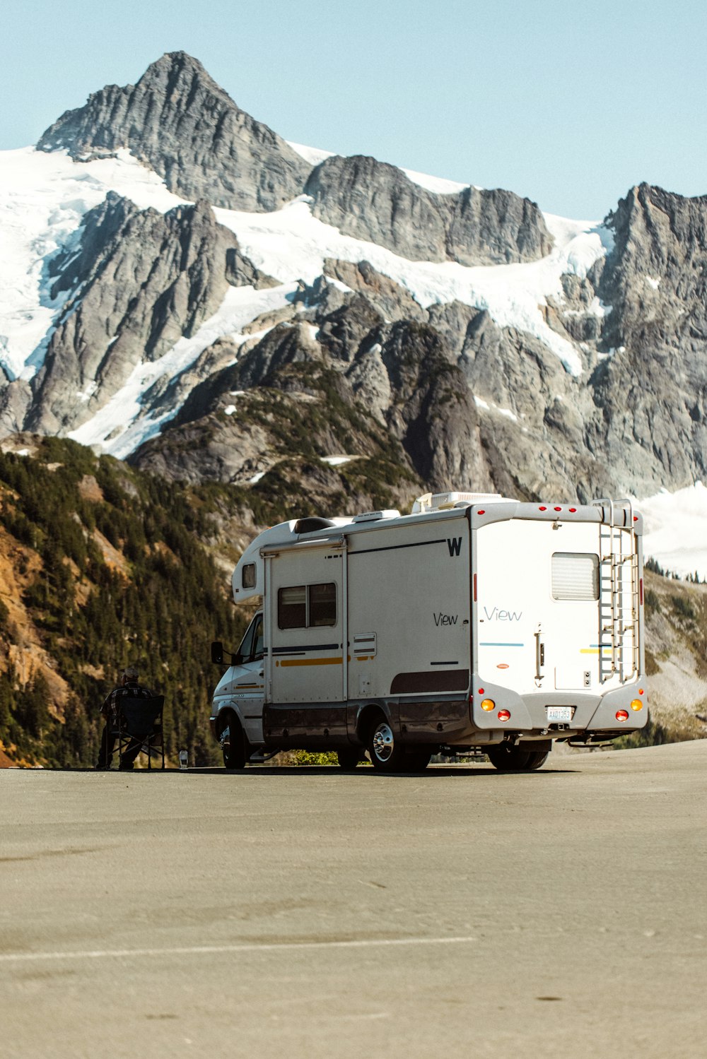 white and brown van on gray asphalt road during daytime