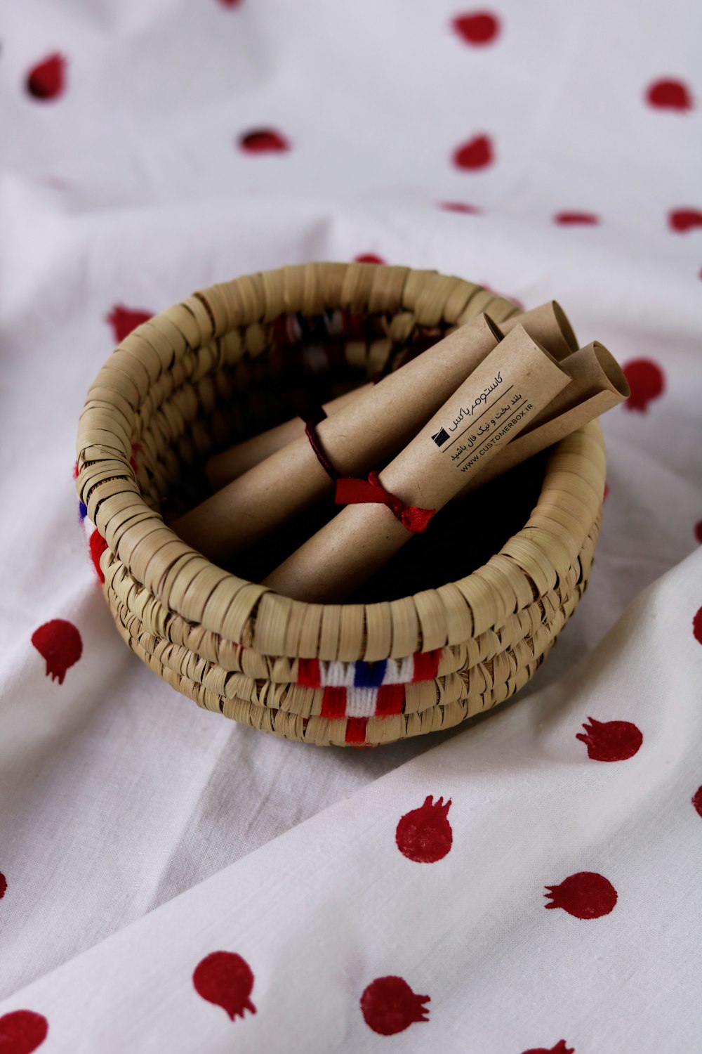 brown woven basket on white textile