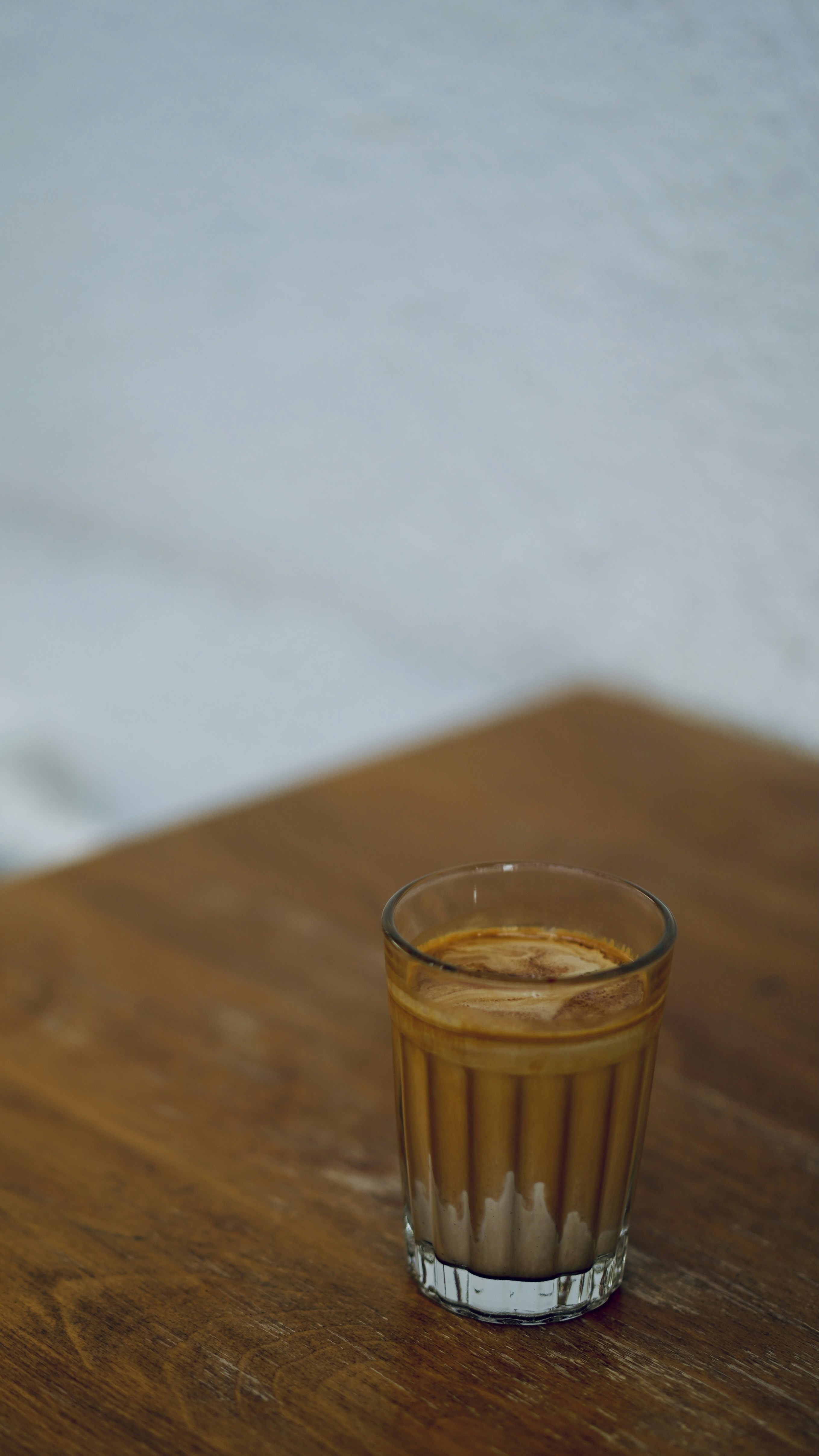 clear drinking glass on brown wooden table