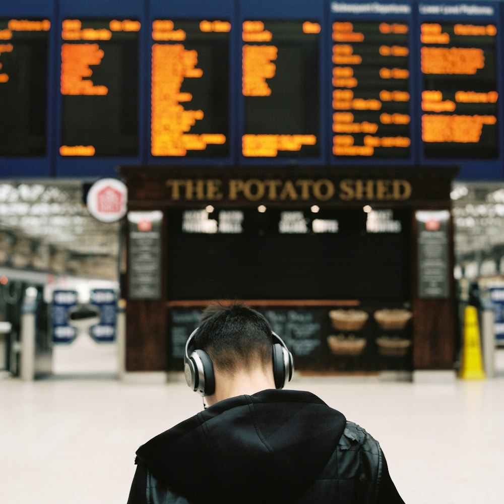 man in black leather jacket wearing black headphones