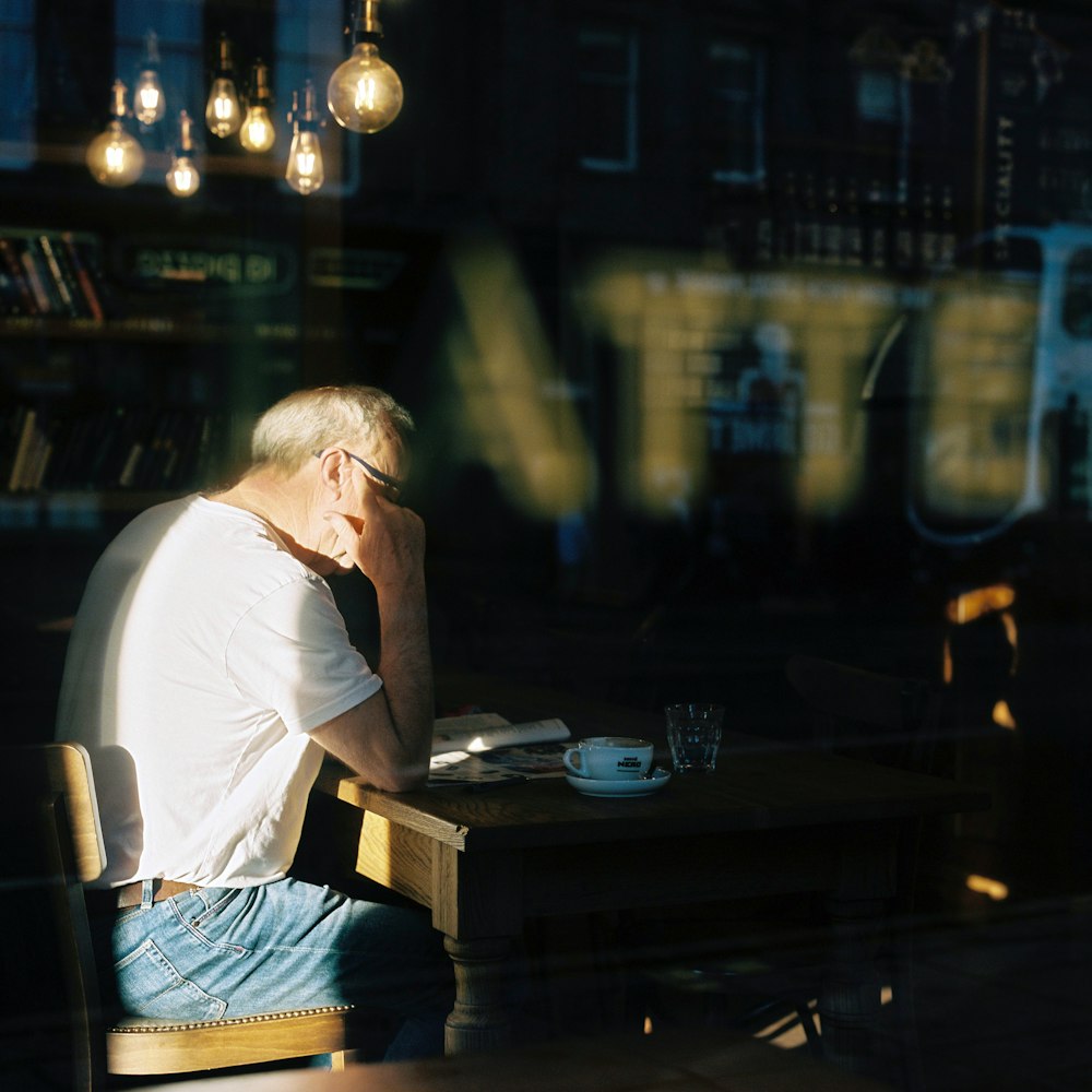 man in white shirt sitting on chair