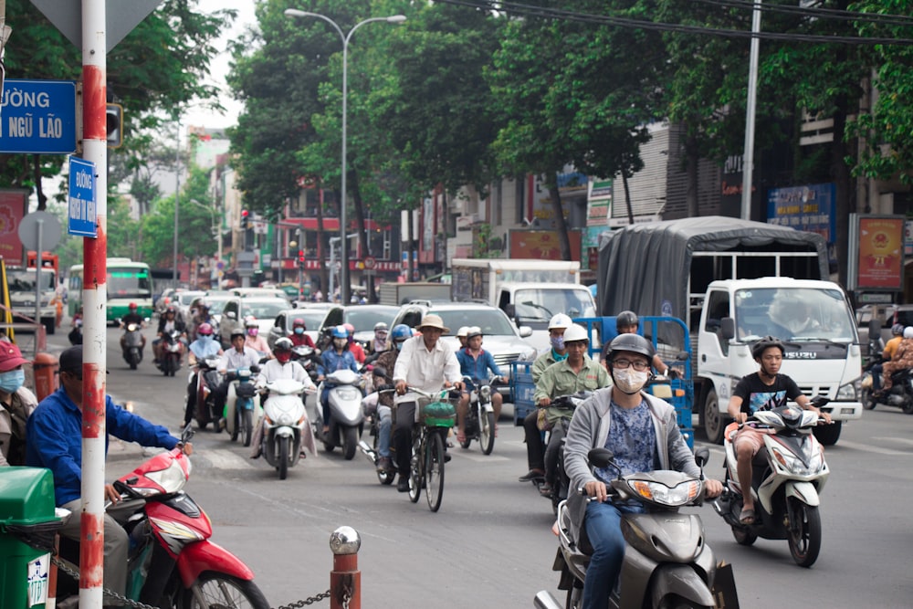 people riding motorcycle on road during daytime