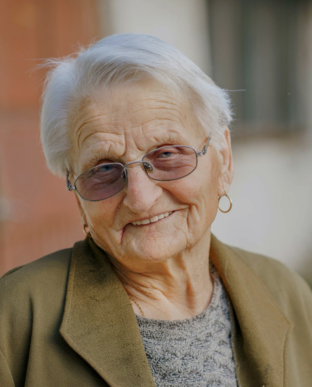 woman in brown coat wearing eyeglasses