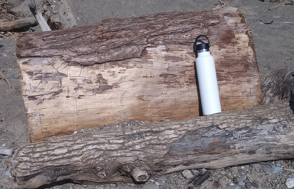 white and black tube on brown wood