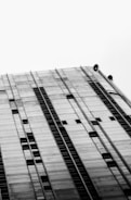 Close-up image of workers applying construction chemicals on a high-rise building in Germany.