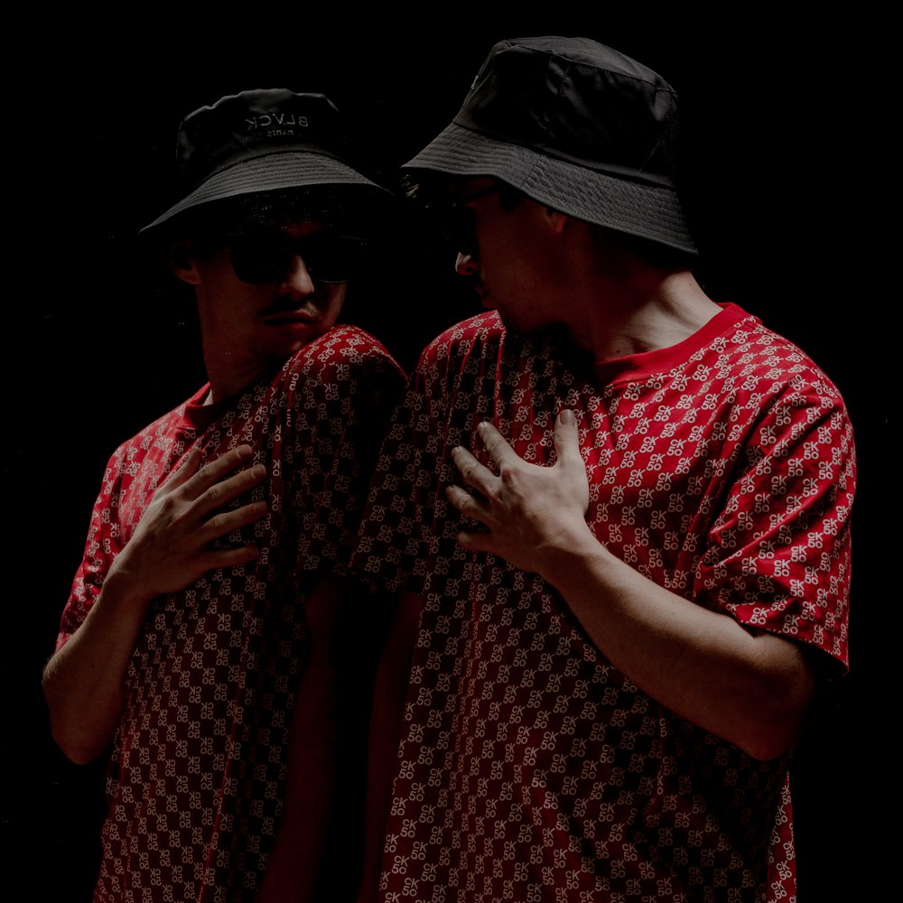 man in red and white shirt wearing black hat