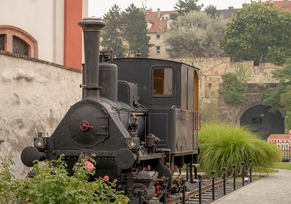 black train on rail tracks during daytime