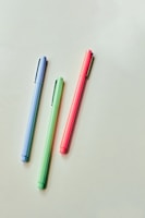 pink and blue pen on white table
