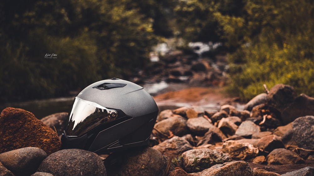 black and white helmet on brown rocky ground