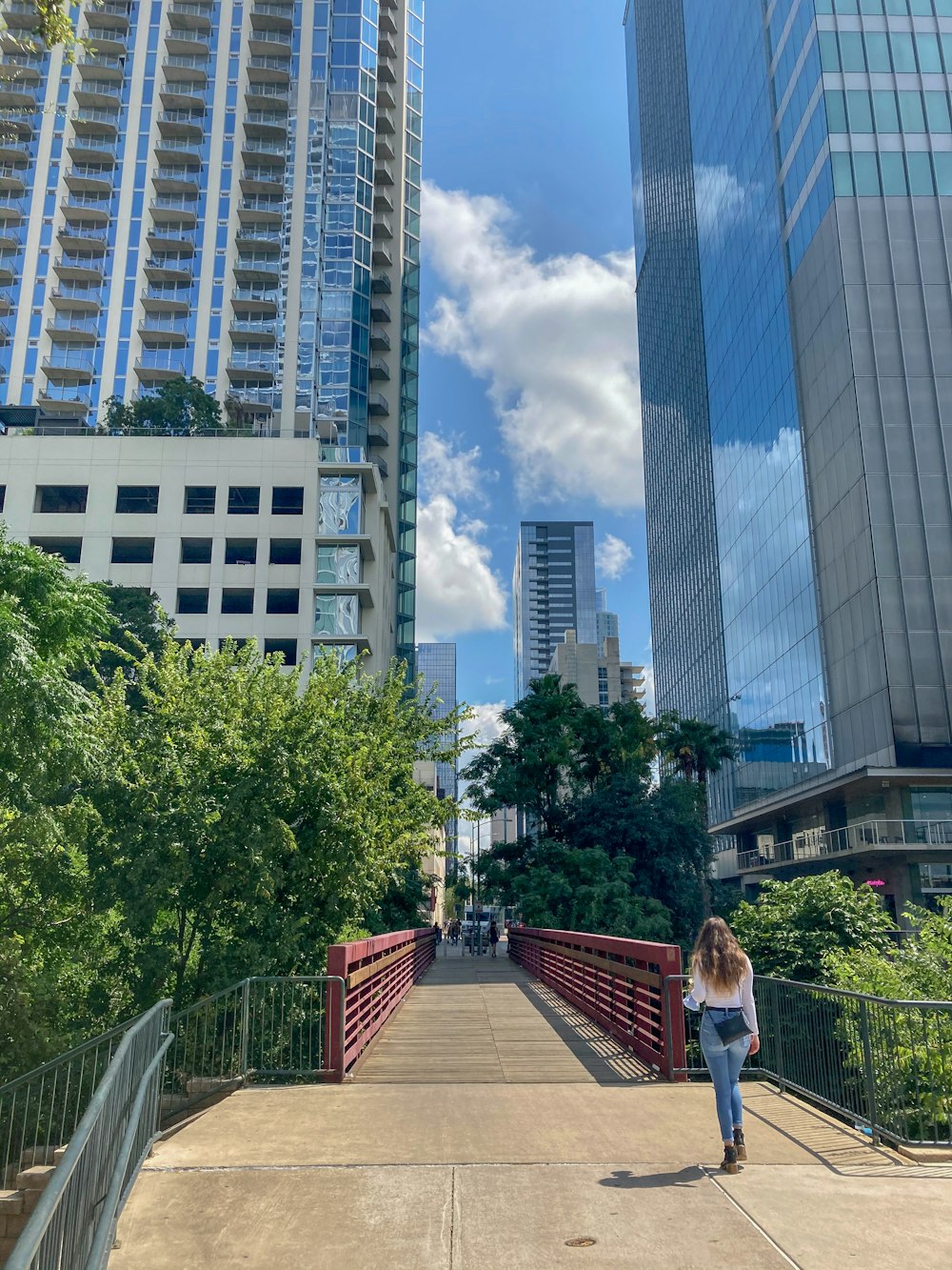 woman in white shirt and black pants standing on brown wooden dock during daytime