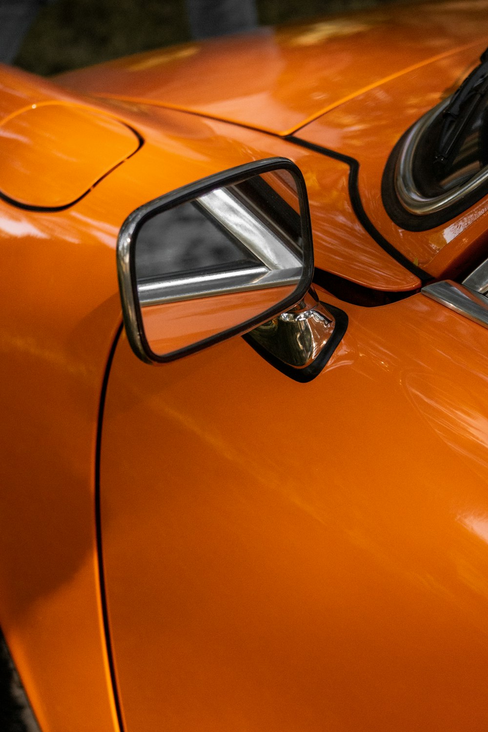 orange car side mirror during daytime