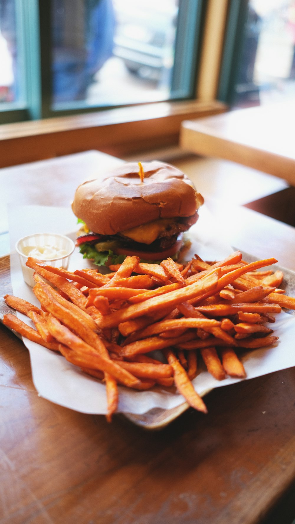 burger and fries on white paper